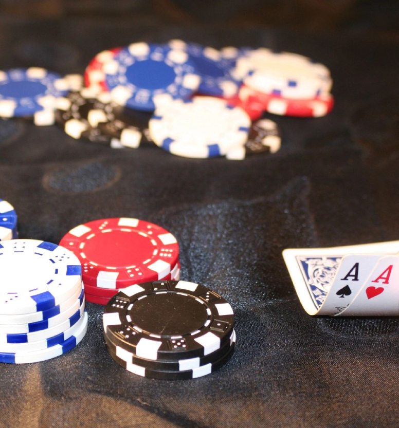 A table with poker chips and cards on it.